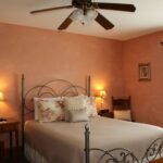 Country Hermitage Bed and Breakfast interior view of guest room with queen bed and ceiling fan