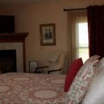 Country Hermitage Bed and Breakfast interior view of guest room with pink bedding and window