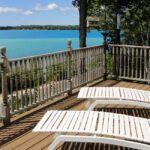 Torch Lake Bed and Breakfast Deck with lounge chairs overlooking water
