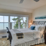 Spring Light House guest Bedroom with white bedding and window off set view
