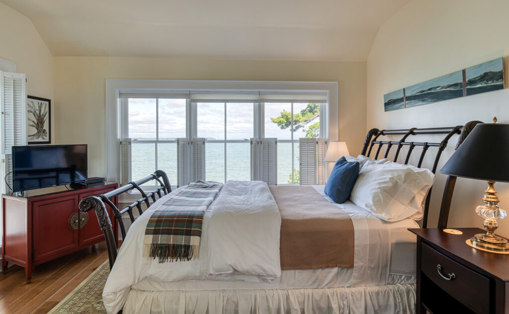 Spring Light House guest Bedroom with white bedding and window view