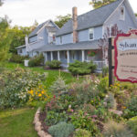 Sylvan Inn Bed and Breakfast Exterior view with sign and springtime flowers